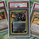 Three valuable Pokémon cards spread across a background image of money.